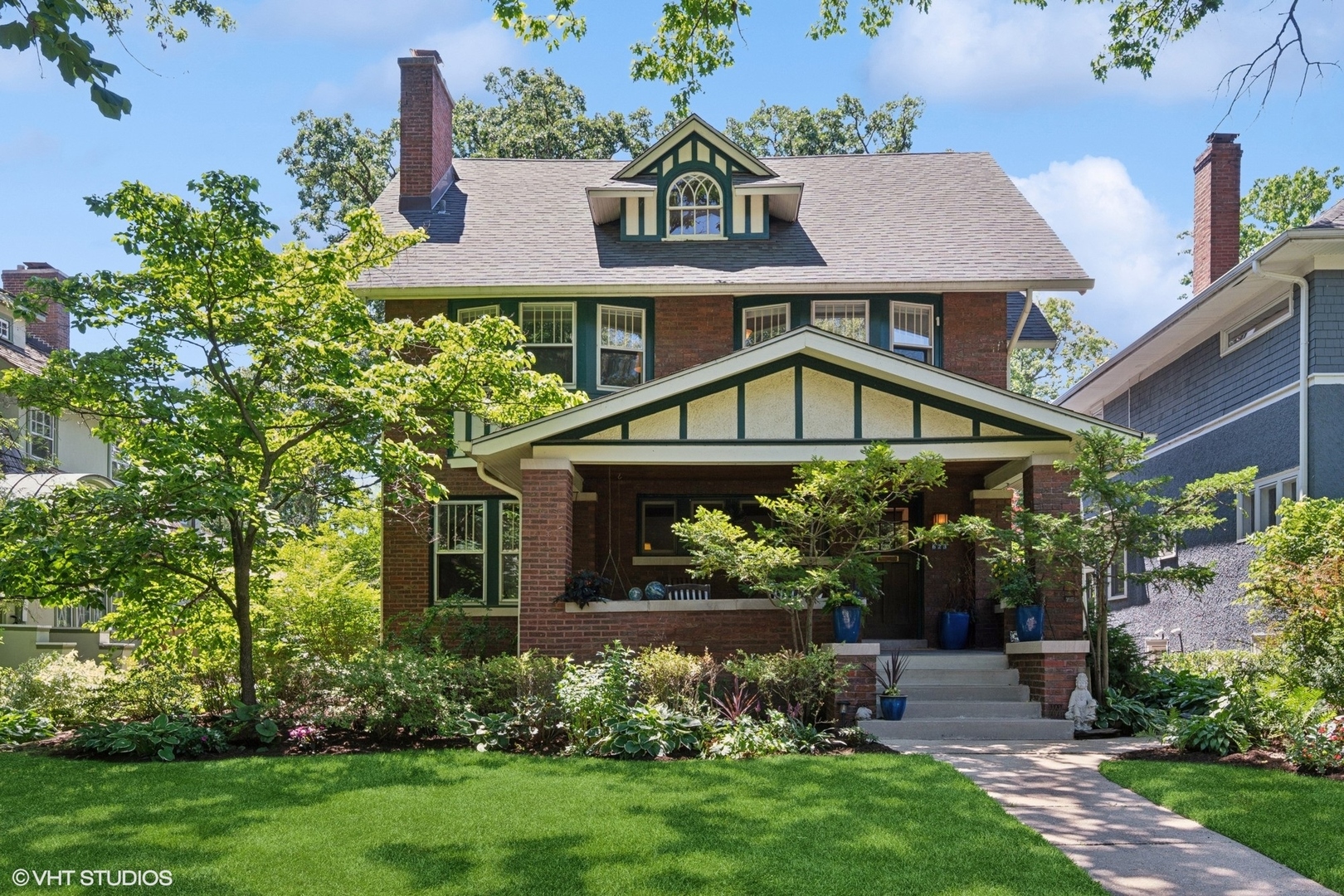 a view of house with garden and a tree