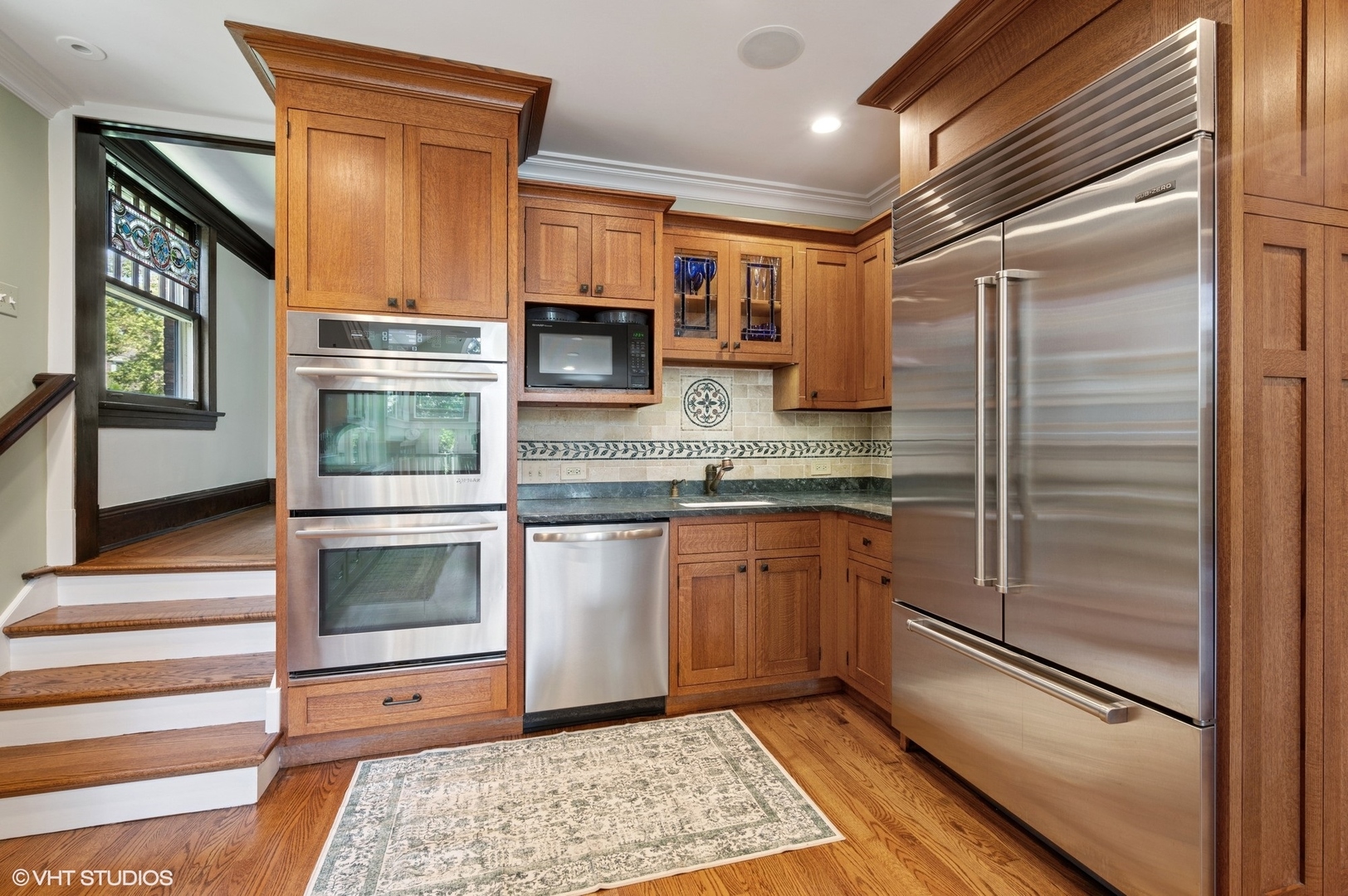623 Forest Avenue Wilmette, IL 60091 - Photo 11 of 43 a kitchen with stainless steel appliances granite countertop a refrigerator a stove and a sink