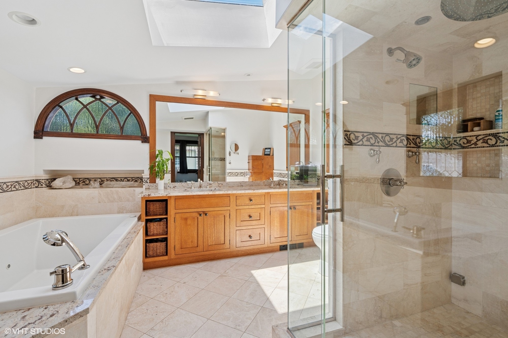 623 Forest Avenue Wilmette, IL 60091 - Photo 19 of 43 a large bathroom with a tub a sink and a large mirror