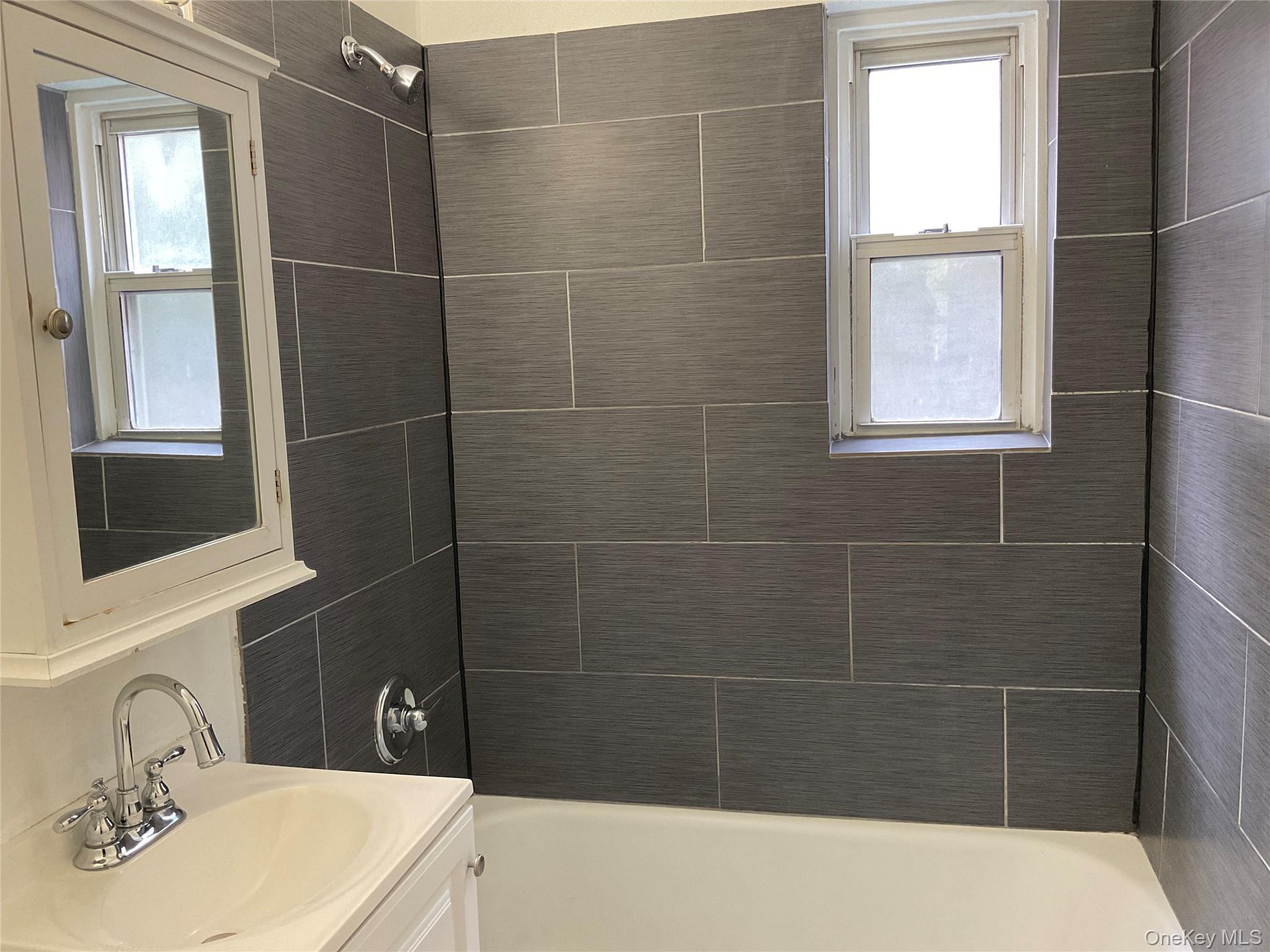 320 South Broadway, Unit P8 Tarrytown, NY 10591 - Photo 18 of 21 a bathroom with a sink a window and shower