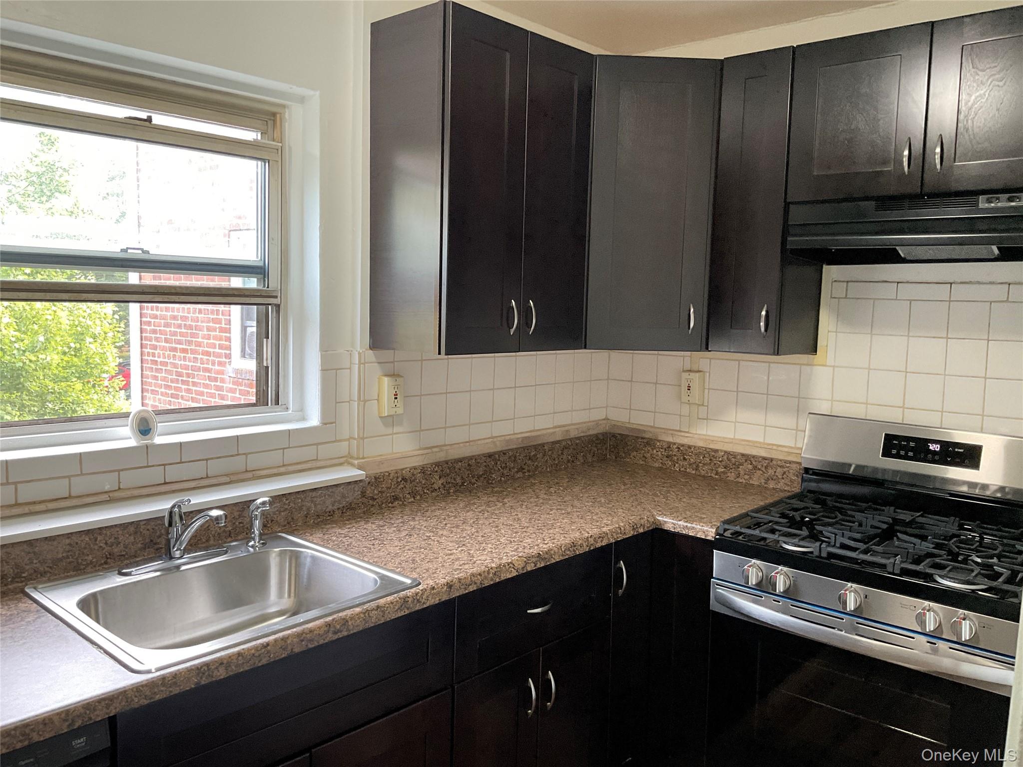 320 South Broadway, Unit P8 Tarrytown, NY 10591 - Photo 10 of 21 a kitchen with granite countertop a sink stainless steel appliances a window and cabinets