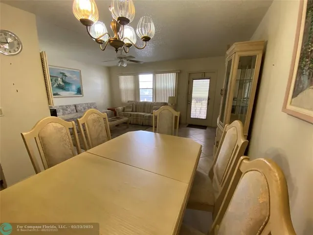 a view of a livingroom with furniture window chandelier