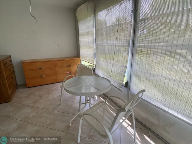 a balcony with table and chairs