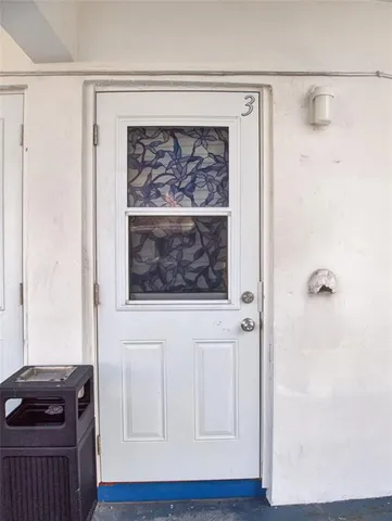 a view of a hallway with entryway wooden floor and front door