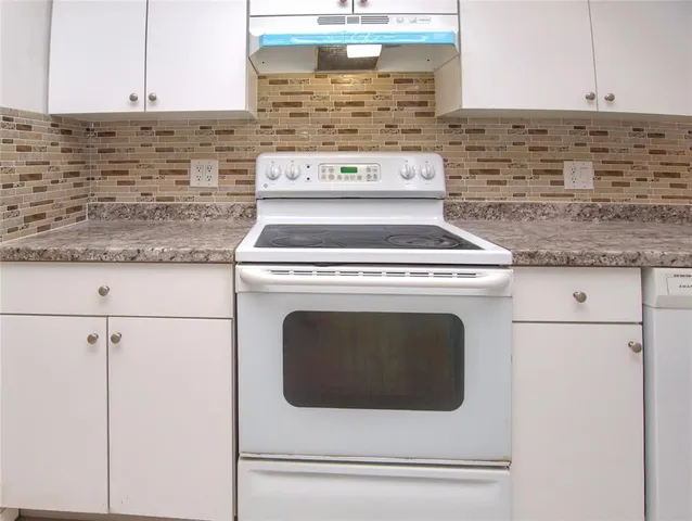 a stove top oven sitting inside of a kitchen