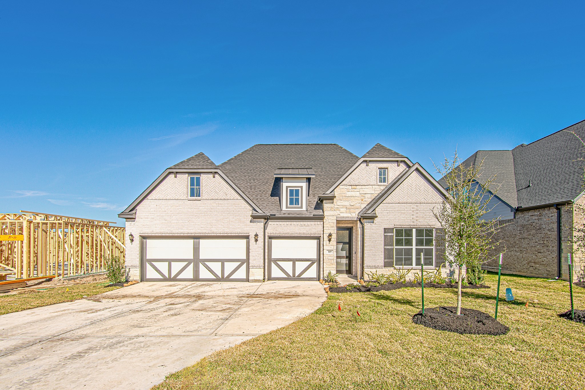 Front exterior showcasing curb appeal, stone façade, and attached garage.