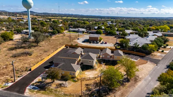 an aerial view of residential houses with outdoor space