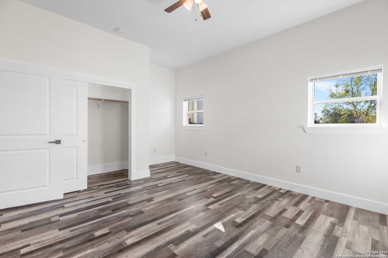705 Fifth Street, Unit B Comfort, TX 78013 - Photo 21 of 30 a view of an empty room with window and a chandelier fan