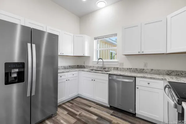 a kitchen with stainless steel appliances granite countertop a stove microwave and sink