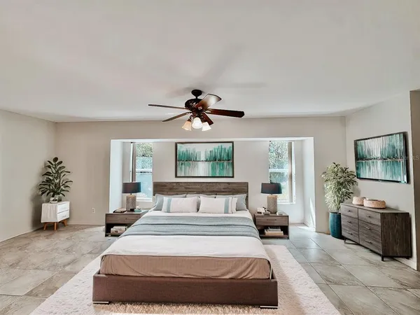 a bedroom with a large bed and a window