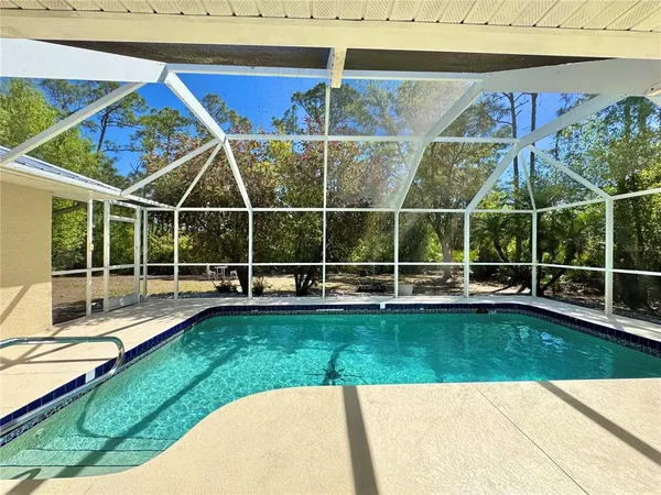 a view of a backyard with a swimming pool