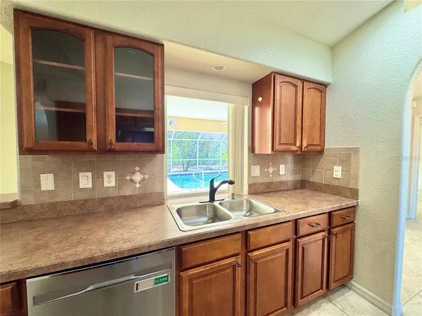 a kitchen with stainless steel appliances granite countertop a sink and a microwave