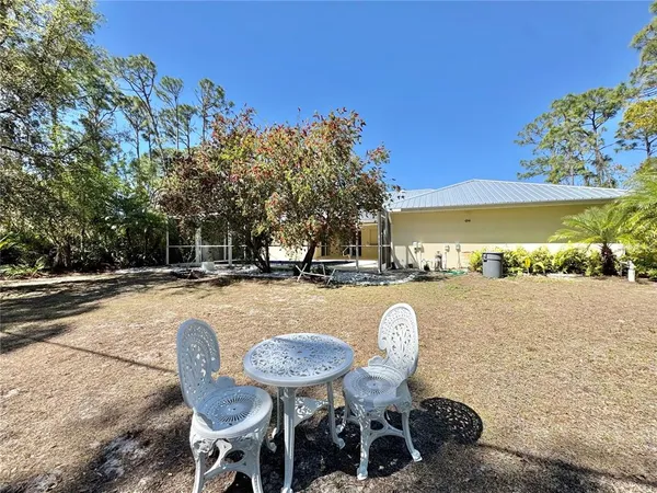 a swimming pool with outdoor seating and yard