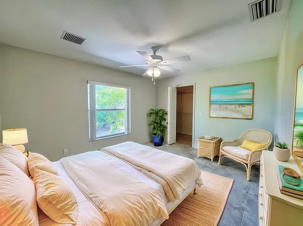 a spacious bedroom with a bed and a couch