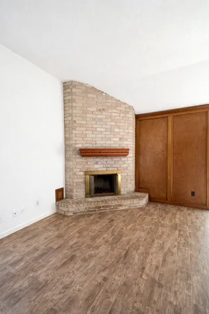 a view of an empty room with a fireplace