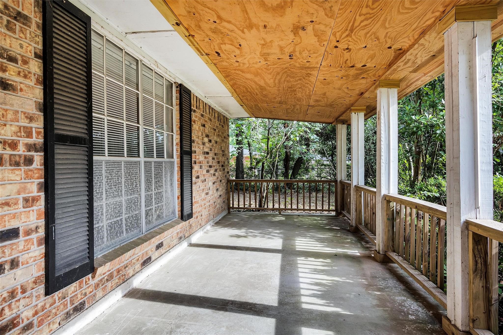 29526 West Hawthorne Drive Spring, TX 77386 - Photo 2 of 13 a view of a porch with wooden floor and roof