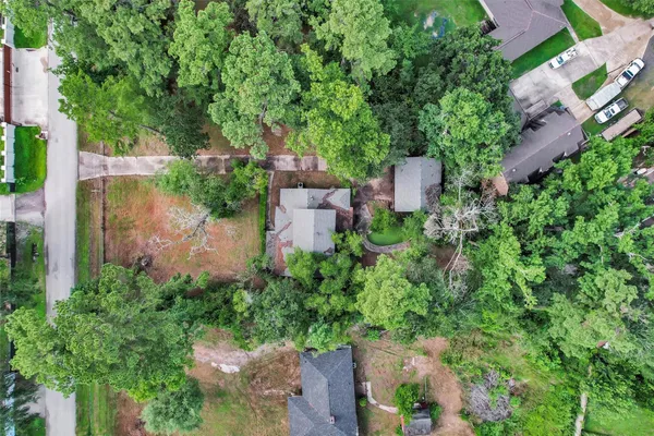 an aerial view of a house with a yard and garden