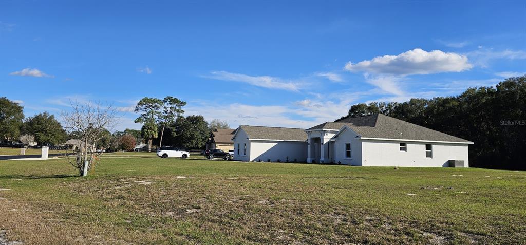 70th Street Silver Springs, FL 34488 - Photo 2 of 30 a front view of a house with a yard and trees