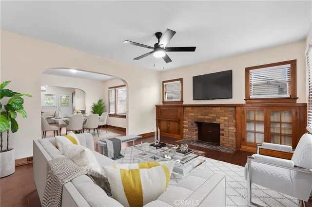 a living room with furniture a fireplace and a flat screen tv