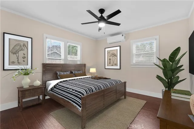 a bedroom with a large bed and a chandelier