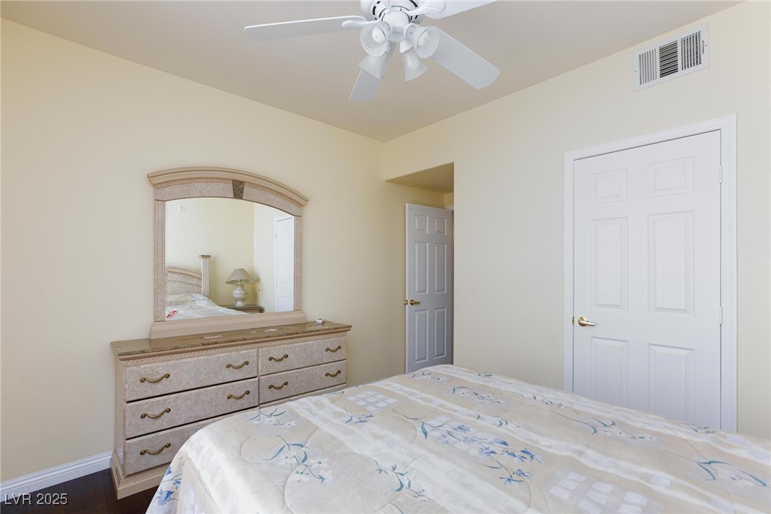 7185 South Durango Drive, Unit 201 Las Vegas, NV 89113 - Photo 14 of 27 Bedroom with ceiling fan with light and dark wood-type flooring