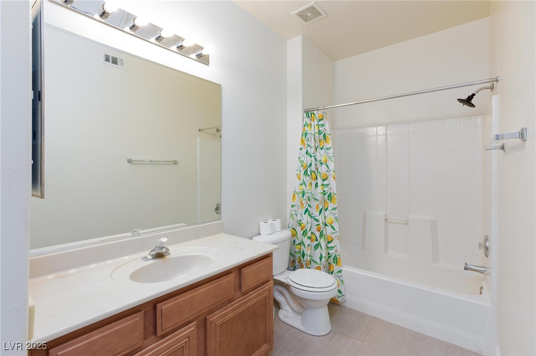 7185 South Durango Drive, Unit 201 Las Vegas, NV 89113 - Photo 15 of 27 Full bathroom with vanity, shower / bath combination with curtain, and light tile patterned floors