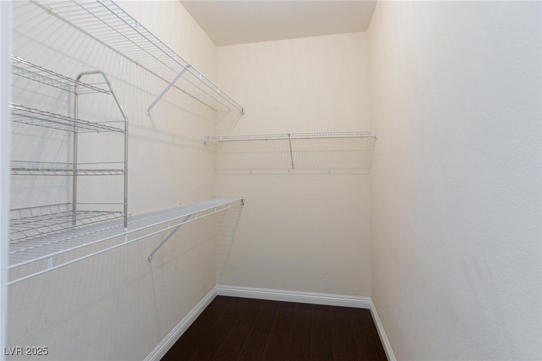 7185 South Durango Drive, Unit 201 Las Vegas, NV 89113 - Photo 20 of 27 Spacious closet with dark wood finished floors