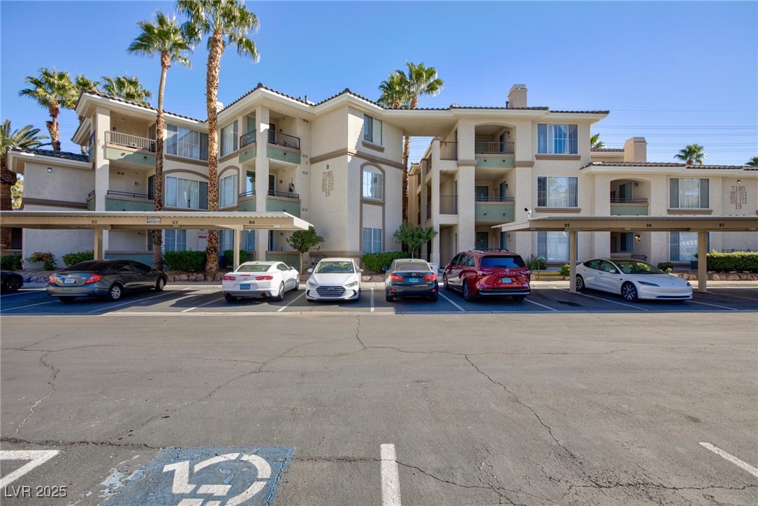 7185 South Durango Drive, Unit 201 Las Vegas, NV 89113 - Photo 23 of 27 View of apartment building / complex with covered and uncovered parking