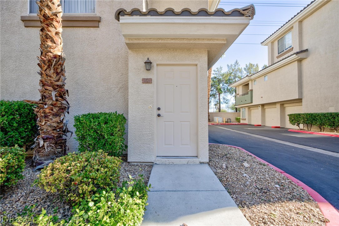 7185 South Durango Drive, Unit 201 Las Vegas, NV 89113 - Photo 3 of 27 Property entrance featuring stucco siding