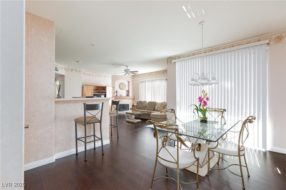 7185 South Durango Drive, Unit 201 Las Vegas, NV 89113 - Photo 5 of 27 Dining space featuring dark wood-type flooring and dining furniture