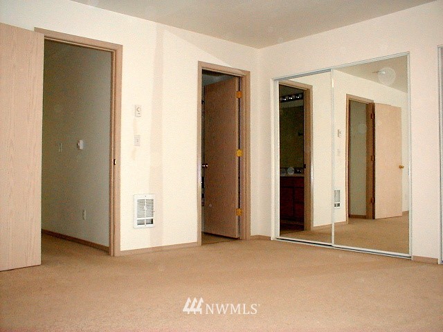 12116 Alexander Road Everett, WA 98204 - Photo 12 of 16 a view of an empty room with closet and a bathroom
