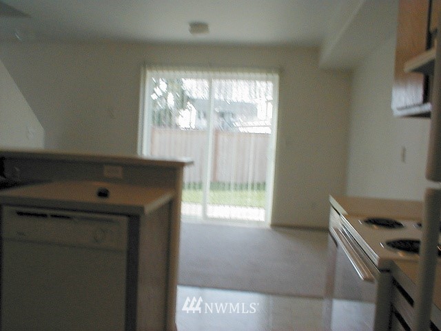 12116 Alexander Road Everett, WA 98204 - Photo 5 of 16 a kitchen with windows and refrigerator