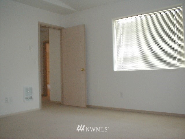 12116 Alexander Road Everett, WA 98204 - Photo 6 of 16 a view of an empty room with a window