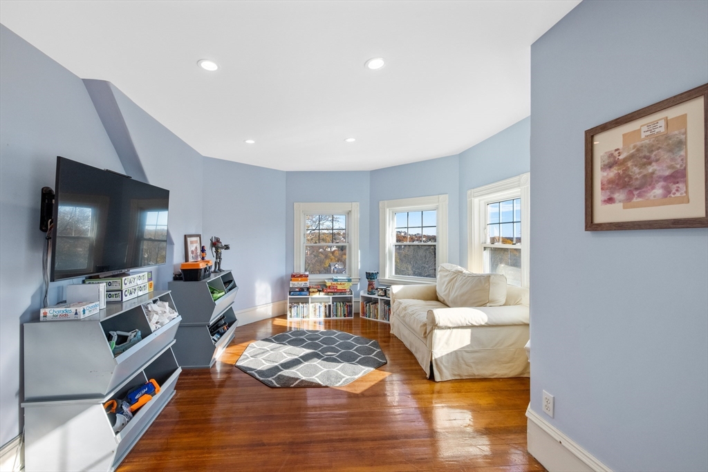 51 Robbins Road Arlington, MA 02476 - Photo 23 of 38 a living room with furniture and a flat screen tv