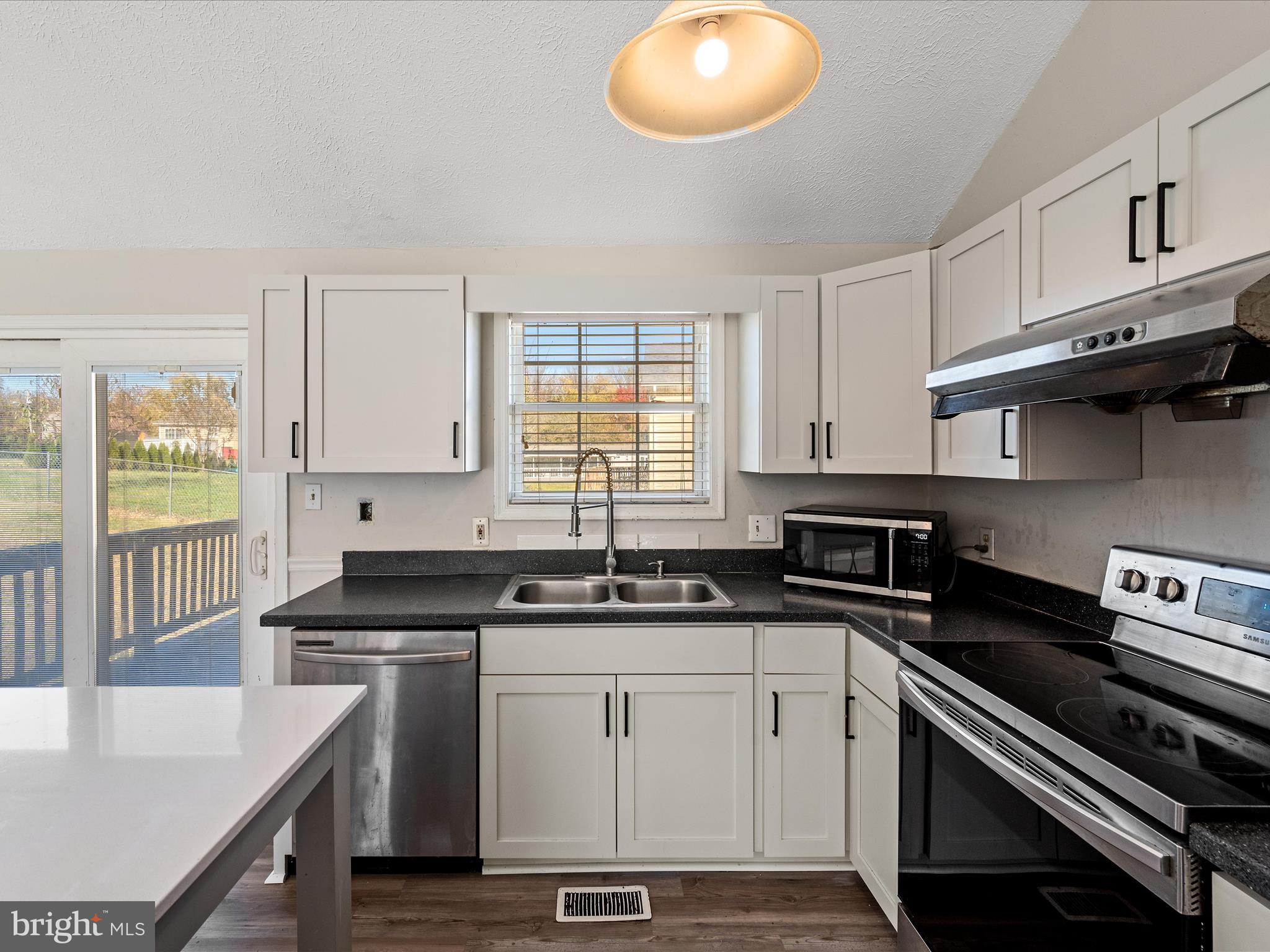 521 East 11th Avenue Ranson, WV 25438 - Photo 11 of 41 a kitchen with a sink stove top oven and cabinets