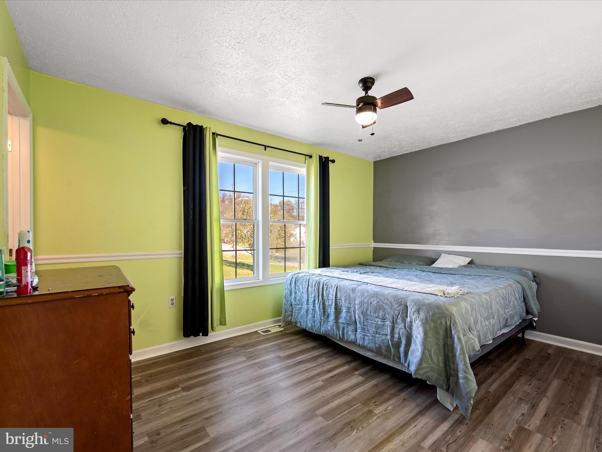 521 East 11th Avenue Ranson, WV 25438 - Photo 13 of 41 a bedroom with a bed and wooden floor