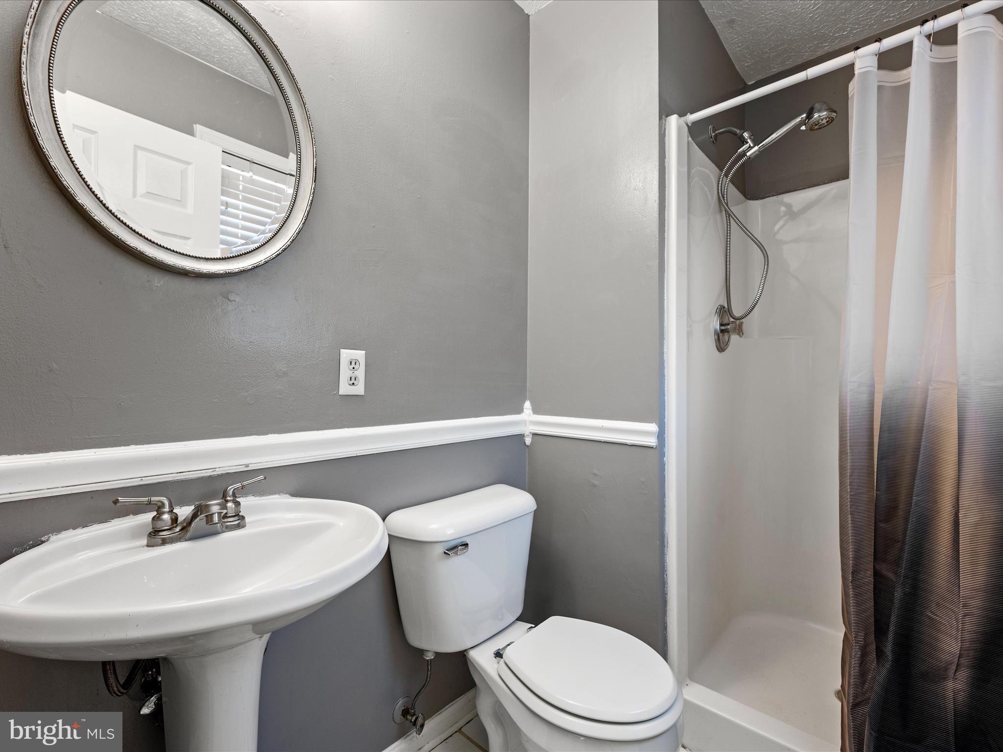 521 East 11th Avenue Ranson, WV 25438 - Photo 15 of 41 a bathroom with a sink a toilet and shower