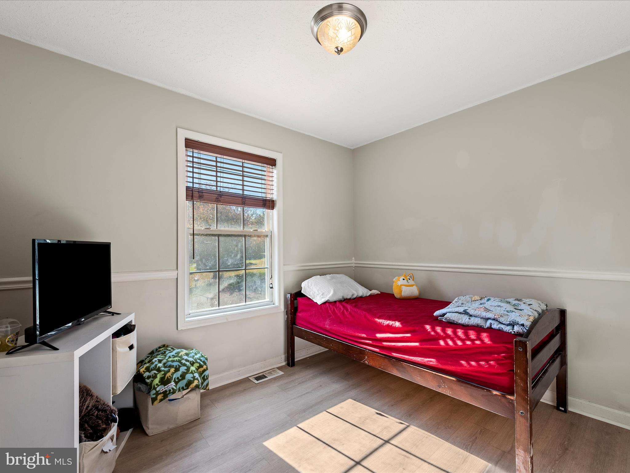 521 East 11th Avenue Ranson, WV 25438 - Photo 18 of 41 a living room with furniture and a flat screen tv