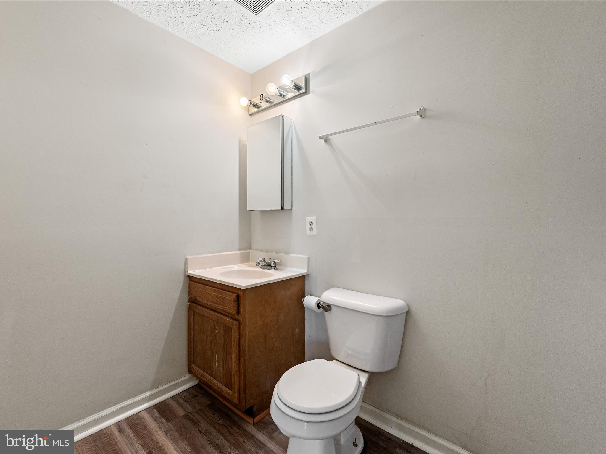 521 East 11th Avenue Ranson, WV 25438 - Photo 26 of 41 a bathroom with a granite countertop toilet and a sink