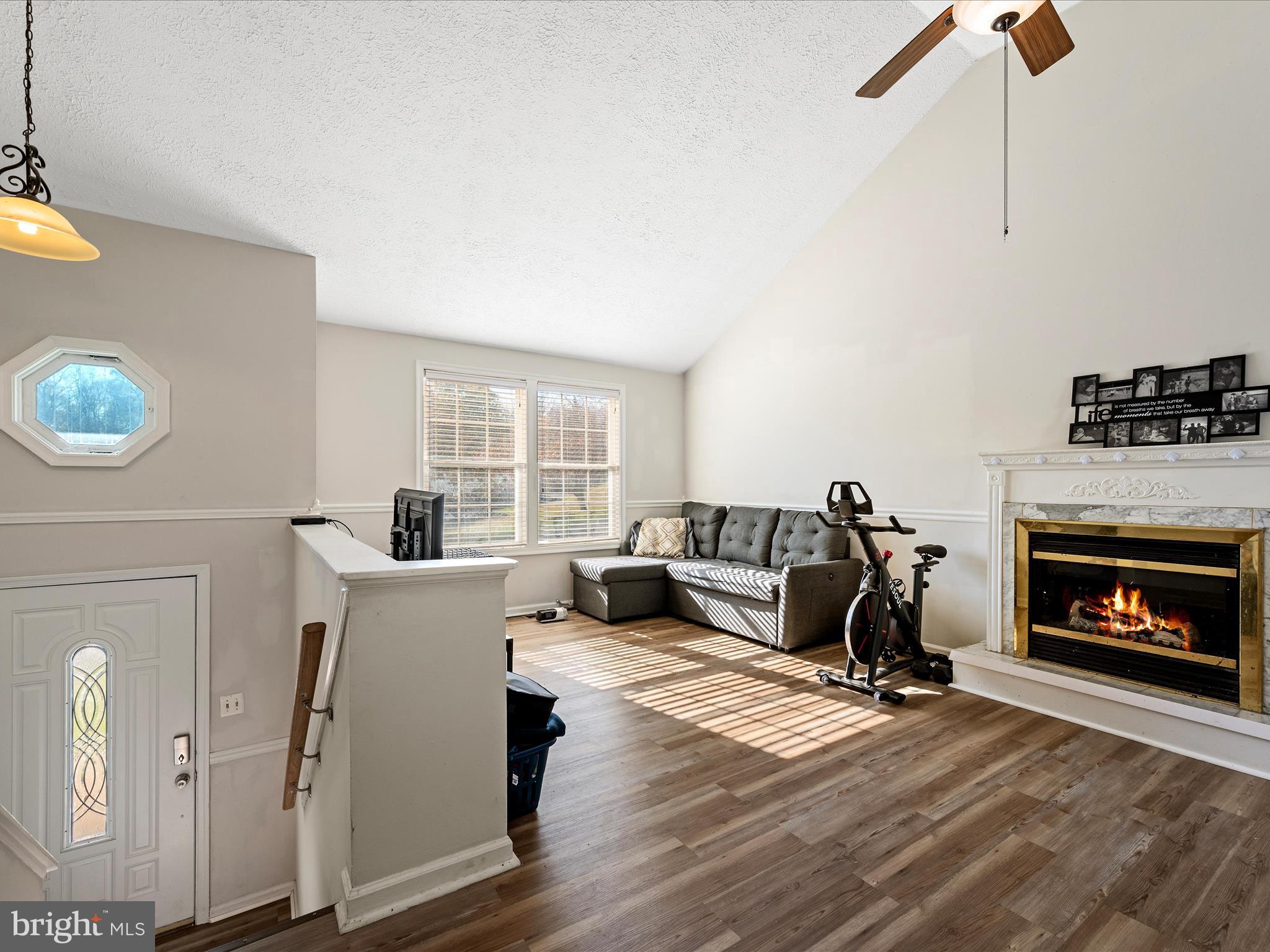 521 East 11th Avenue Ranson, WV 25438 - Photo 5 of 41 a living room with furniture a fireplace and a window
