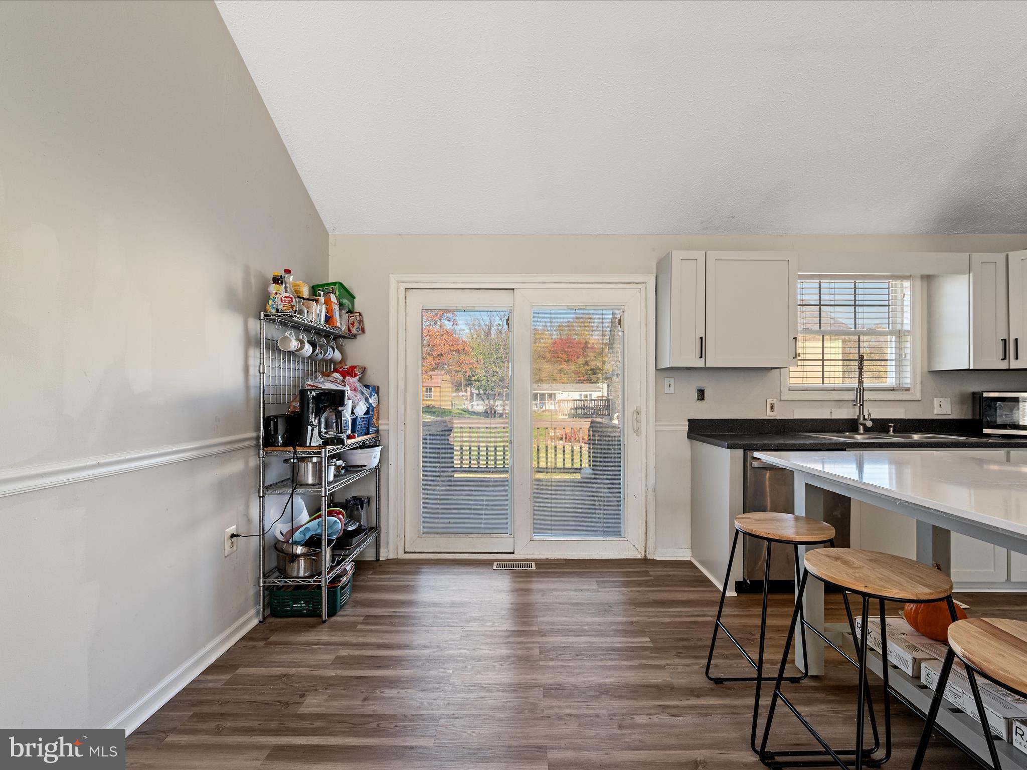 521 East 11th Avenue Ranson, WV 25438 - Photo 7 of 41 a kitchen with stainless steel appliances wooden floor and a window