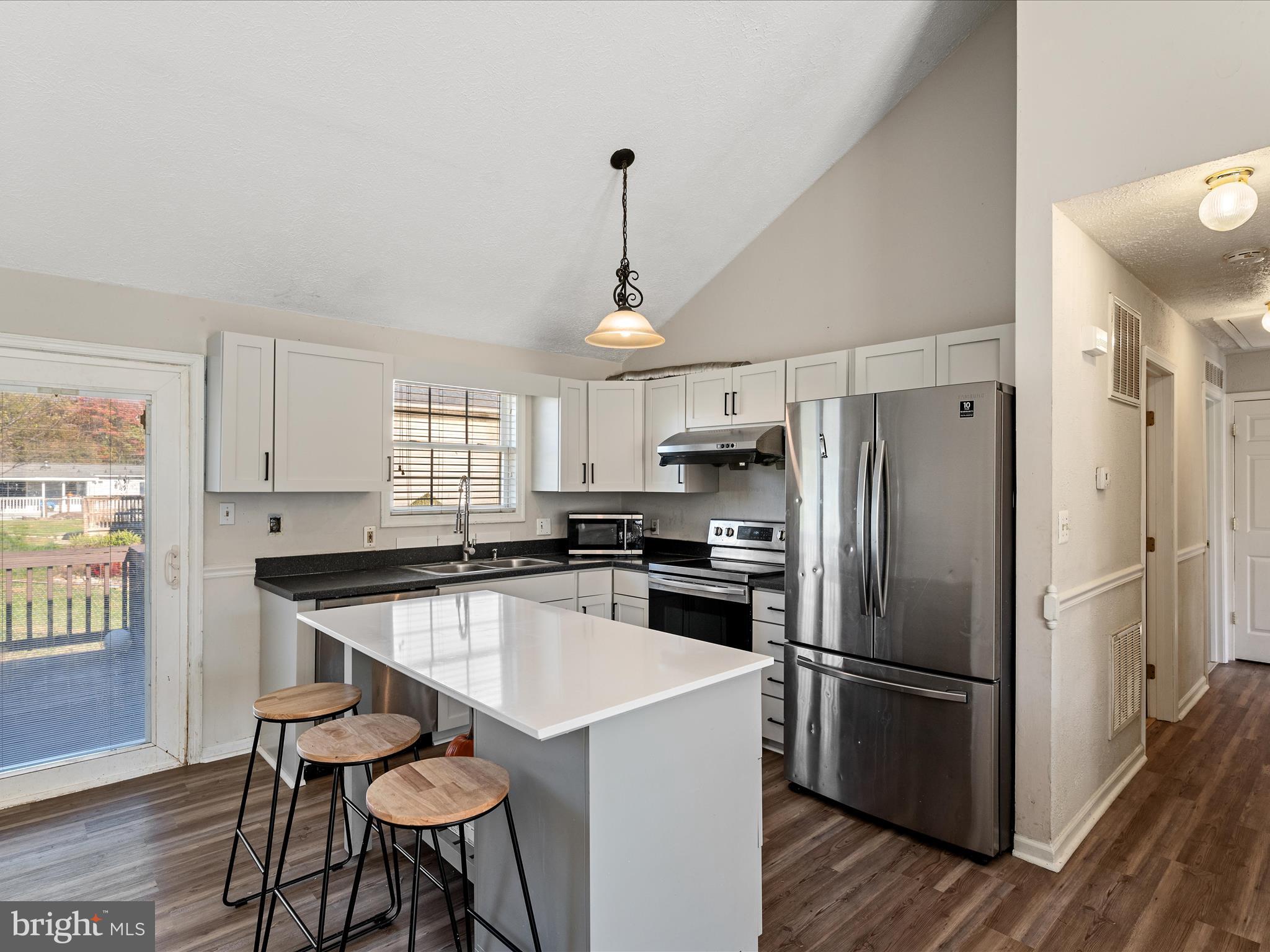 521 East 11th Avenue Ranson, WV 25438 - Photo 8 of 41 a kitchen with stainless steel appliances a refrigerator a stove a sink and white cabinets