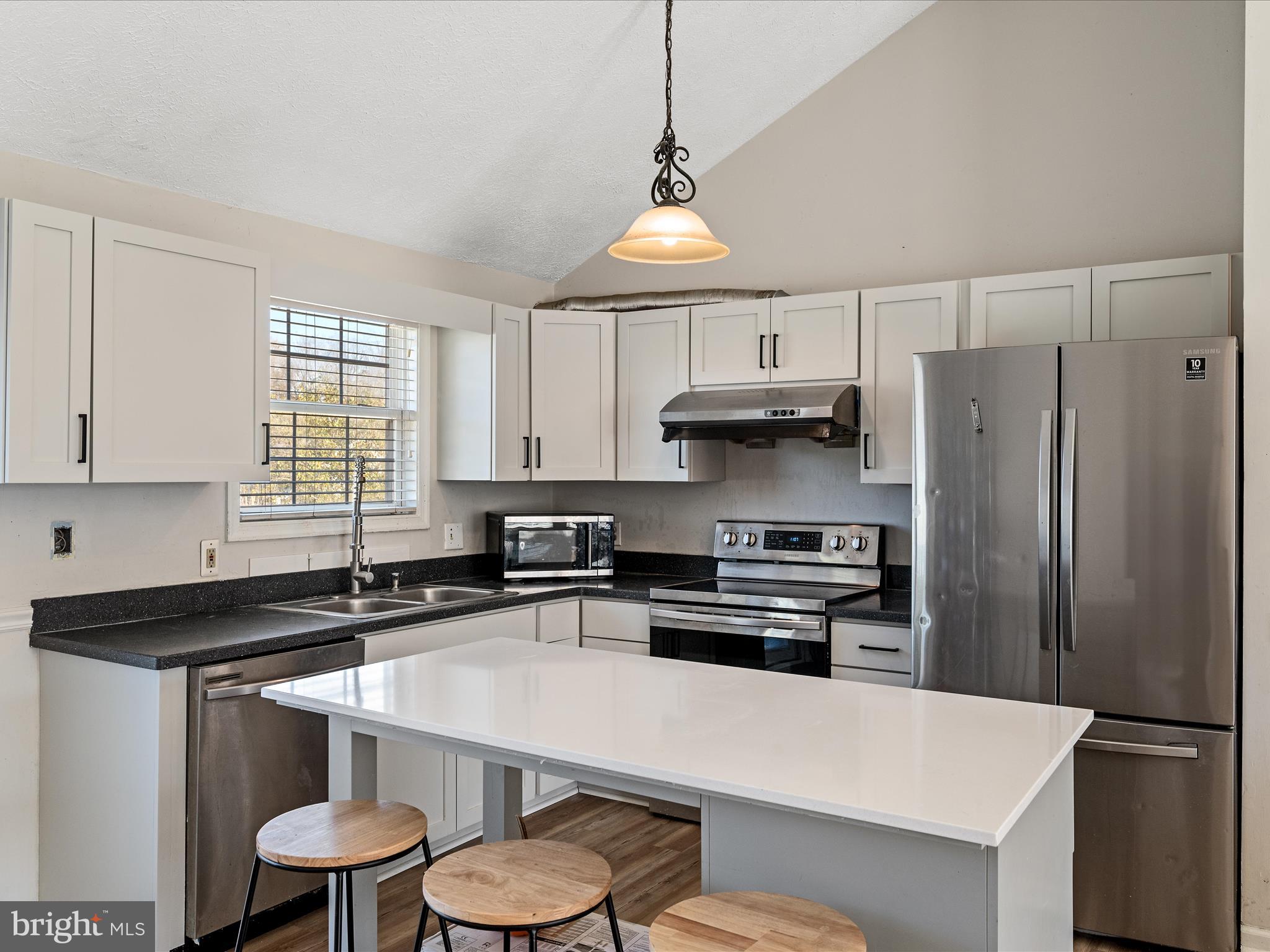521 East 11th Avenue Ranson, WV 25438 - Photo 9 of 41 a kitchen with stainless steel appliances a sink a stove a refrigerator and cabinets