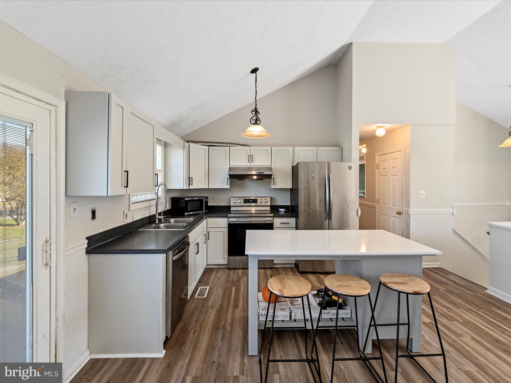 521 East 11th Avenue Ranson, WV 25438 - Photo 10 of 41 a large kitchen with a table and chairs