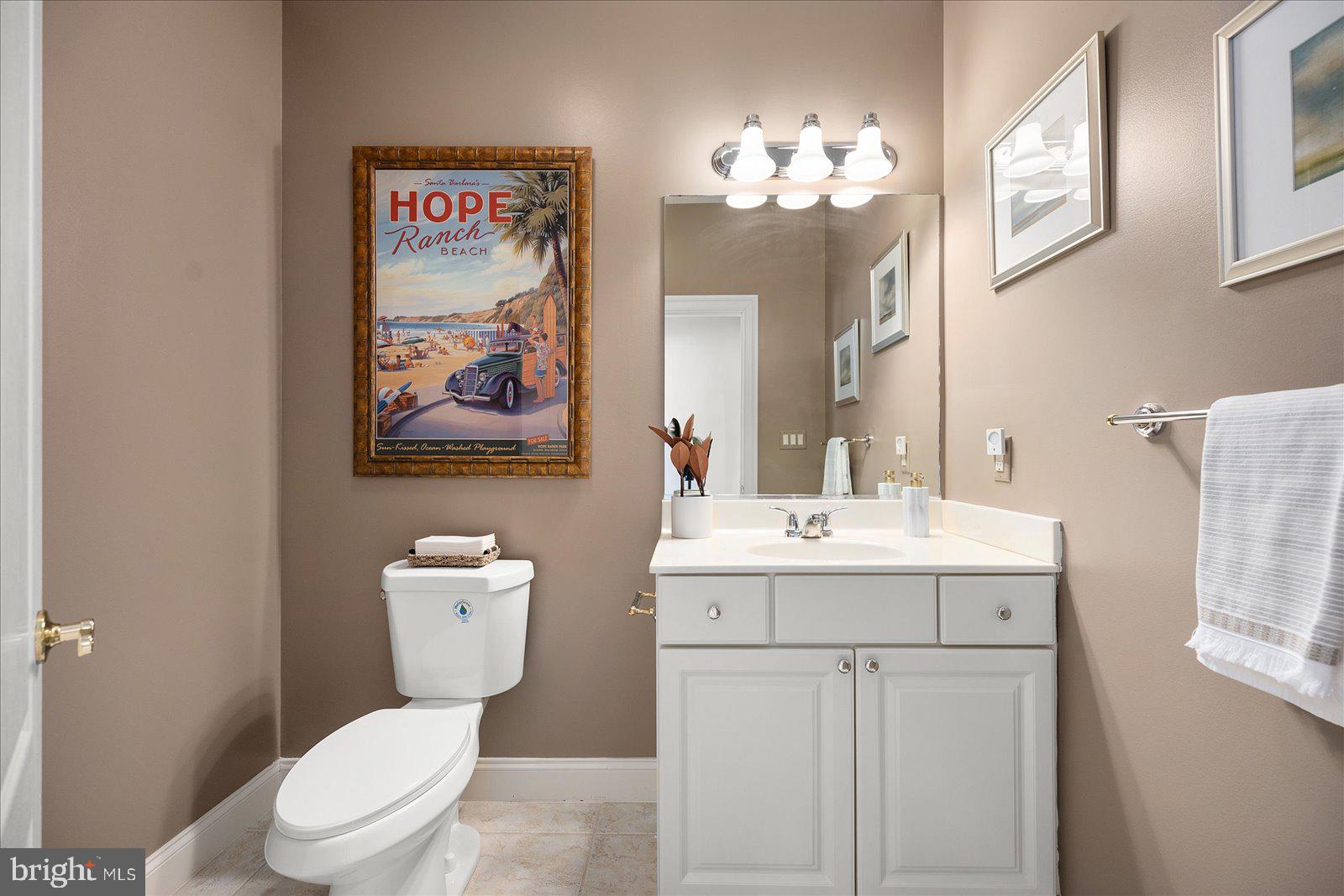 12901 Old Bridge Road, Unit PH8 2 Ocean City, MD 21842 - Photo 19 of 79 a bathroom with a toilet a sink and a mirror