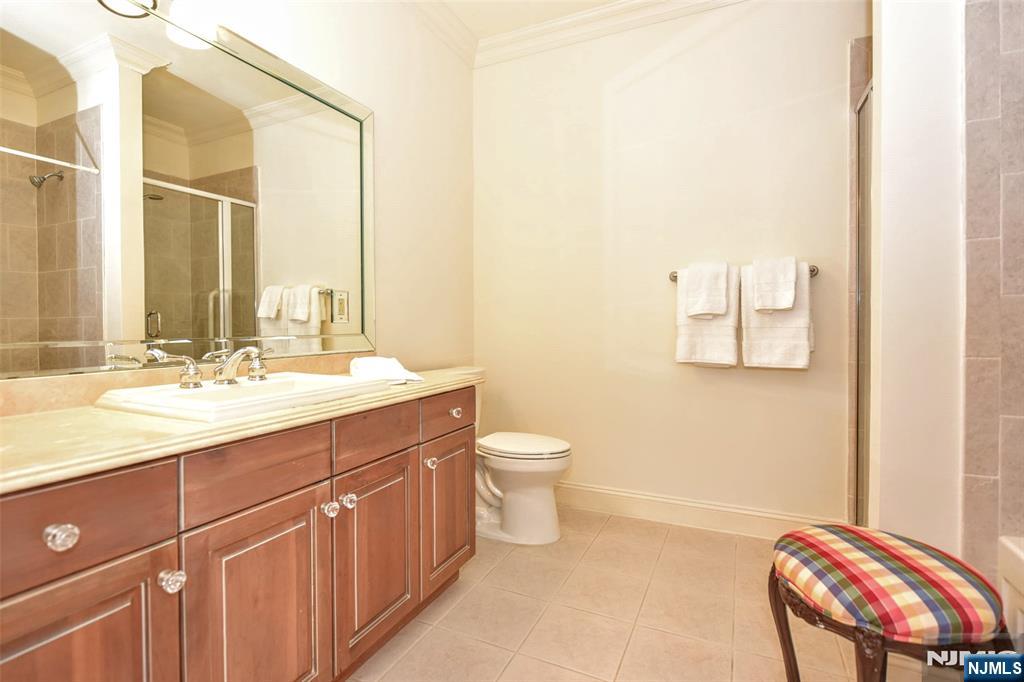 4201 Rio Vista Drive, Unit 4201 Mahwah, NJ 07430 - Photo 14 of 34 a bathroom with a double vanity sink toilet and a mirror