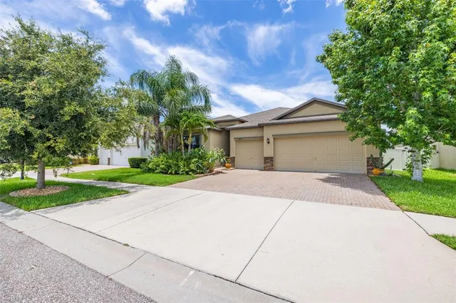 a front view of house with yard and green space
