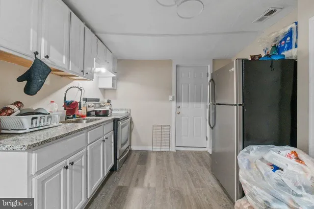 a kitchen with a refrigerator and a sink