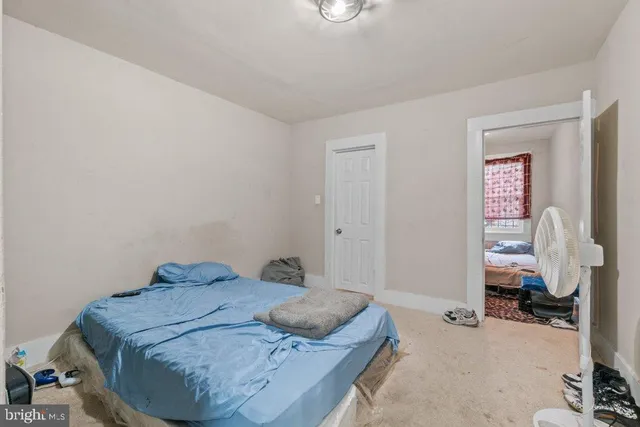 a bedroom with a bed and a table in it