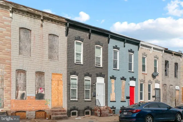 a front view of a building with parking